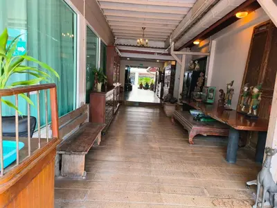 a hallway of a building with benches and plants at Tanwa Suite - MRT Ratchadapisek in Bangkok