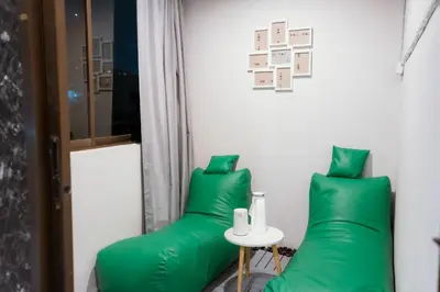 a room with green pillows and a table at 420 Hostel - Ekkamai Buds & Beds in Bangkok