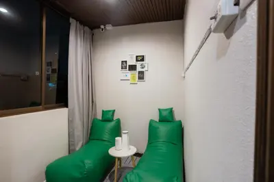 a room with two green pillows and a table at 420 Hostel - Ekkamai Buds & Beds in Bangkok