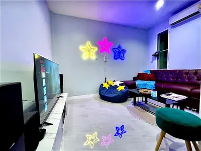 a living room with a couch and stars on the wall at S52 Near On nut BTS 300m*7-11 in Phra Khanong