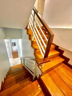 a staircase with wood floors and a wooden railing at S52 Near On nut BTS 300m*7-11 in Phra Khanong