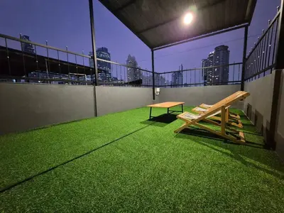 a bench on a balcony with a view of the city at Bangkok vibe, City House, 7 mins to BTS, City center, Private room in Sathon, Private bathroom, Bangkok, Thailand in Bangkok