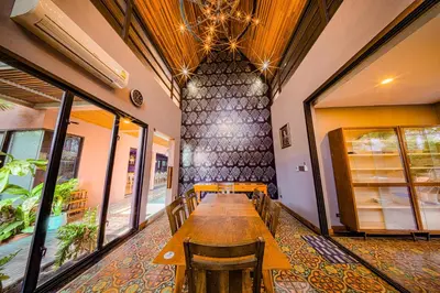 a dining room with a long table and chairs at 189summer villa曼谷中心Asok&Thong Lor顶级豪宅庄园泳池别墅 in Bangkok
