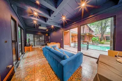 a living room with a blue couch and a table at 189summer villa曼谷中心Asok&Thong Lor顶级豪宅庄园泳池别墅 in Bangkok
