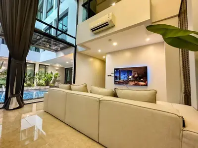 a living room with a couch and a tv at 1897summer villa 曼谷中心7卧Asok&Thong Lor800平米海天别墅 in Bangkok
