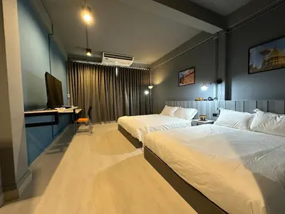 a hotel room with two beds and a television at Chiangmai vibe, City House, 7 mins to BTS, City center, Private room in Sathon, Private bathroom, Bangkok, Thailand in Bangkok