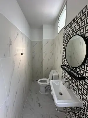 a bathroom with a toilet and a sink and a mirror at Chiangmai vibe, City House, 7 mins to BTS, City center, Private room in Sathon, Private bathroom, Bangkok, Thailand in Bangkok
