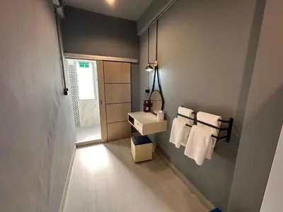 a bathroom with a sink and towels on a wall at Chiangmai vibe, City House, 7 mins to BTS, City center, Private room in Sathon, Private bathroom, Bangkok, Thailand in Bangkok