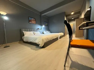 a bedroom with a bed and a table and a chair at Chiangmai vibe, City House, 7 mins to BTS, City center, Private room in Sathon, Private bathroom, Bangkok, Thailand in Bangkok