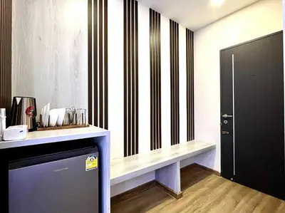 a room with a counter and a black and white striped wall at DiscoveryHome5 at Pratunammarket in Bangkok