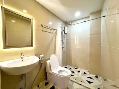 a bathroom with a toilet and a sink and a shower at DiscoveryHome5 at Pratunammarket in Bangkok