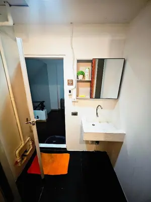 a bathroom with a sink and a mirror at Panda Lodge Home Stay in Bangkok