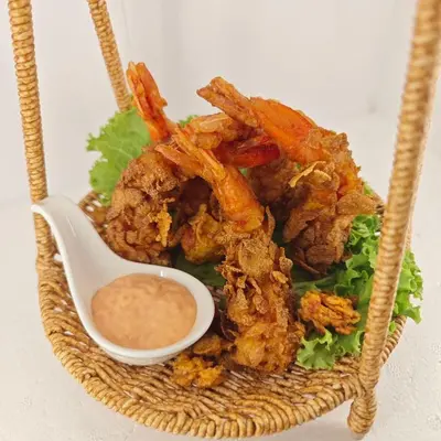 a basket of fried food with a bowl of dipping sauce at Panda Lodge Home Stay in Bangkok