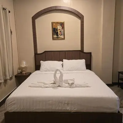a bedroom with a bed with a towel on it at Victory place 2 (Golden Mount) in Bangkok