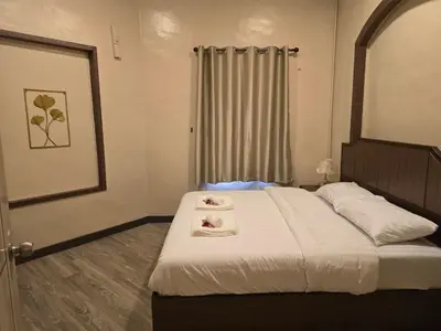 a bedroom with a bed with two towels on it at Victory place 2 (Golden Mount) in Bangkok