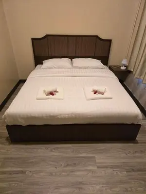 a bedroom with a bed with two towels on it at Victory place 2 (Golden Mount) in Bangkok