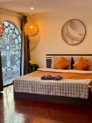 a bedroom with a large bed with a window at Private House 3 Suite Beds + Double Beds in Heart of Phromphong in Bangkok