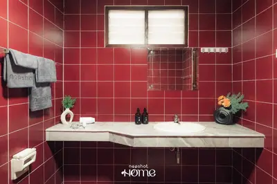 a red tiled bathroom with a sink and a mirror at Private House 3 Suite Beds + Double Beds in Heart of Phromphong in Bangkok