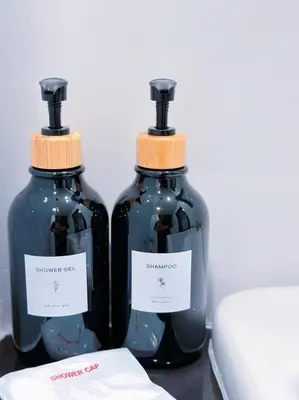two bottles of soap sitting on top of a table at 14 Sathorn Hotel in Bangkok