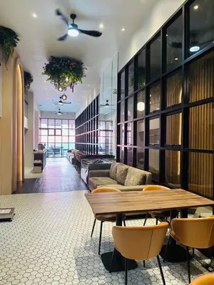 a living room with a couch and a table at 14 Sathorn Hotel in Bangkok