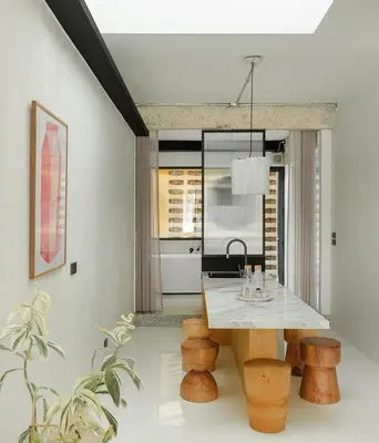 a kitchen with a table and some wooden stools at Stupid Stay in Bangkok