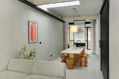 a living room with a couch and a table at Stupid Stay in Bangkok