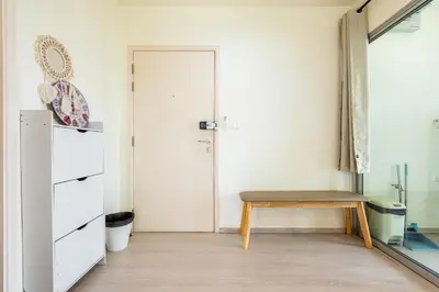 a room with a wooden bench and a door at 2BR, 6 Mins walk BTS Wuttakat in Bangkok