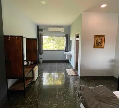 an empty living room with a large window and a floor at IMM Resort in Bangkok