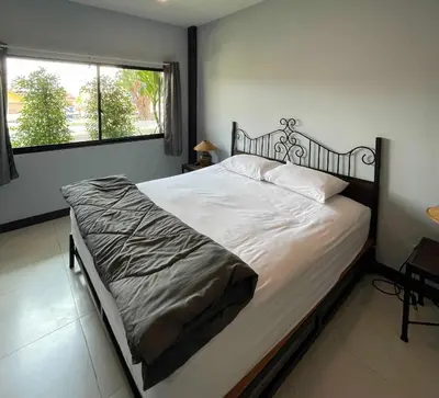 a large bed in a bedroom with a window at IMM Resort in Bangkok