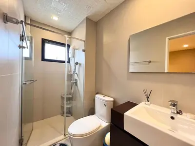 a bathroom with a toilet and a sink and a shower at Free pick up and Stunning Luxury Family Home 2B2B in Bangkok