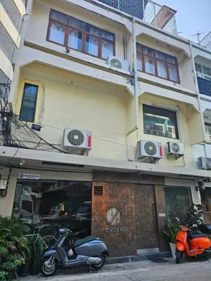 a motorcycle parked in front of a building at Yaowarat Stay in Bangkok