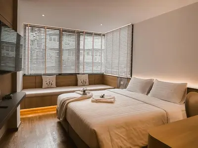 a bedroom with a large bed and a couch at Townhouse PK Garden in Bangkok