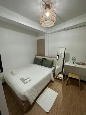 a bedroom with a large bed and a desk at Thai Siwilai Hostel in Bangkok