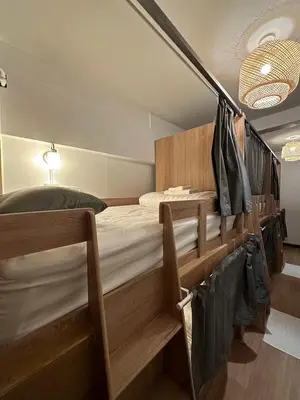 a bedroom with two bunk beds in a room at Thai Siwilai Hostel in Bangkok
