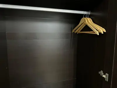 a closet with a wooden hanger in a bathroom at Muangthong p2 in Ban Song Hong