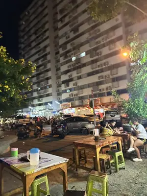 a group of tables and chairs in front of a building at Muangthong p2 in Ban Song Hong