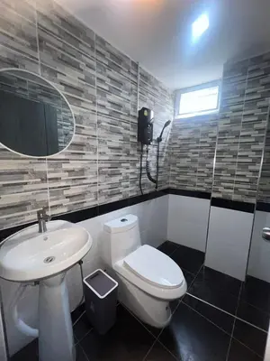a bathroom with a white toilet and a sink at Inntown in Amphoe Phra Khanong