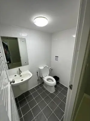 a bathroom with a toilet and a sink at The Lake Guest House in Ban Bang Phang
