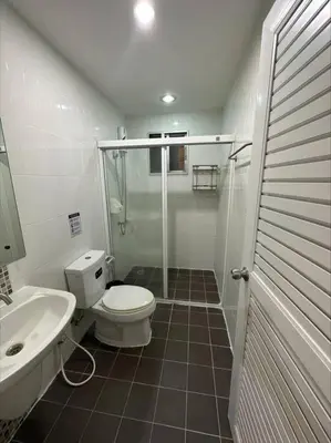 a bathroom with a shower and a toilet and a sink at The Lake Guest House in Ban Bang Phang