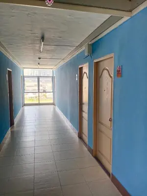 an empty hallway with blue walls and two doors at jw place รามคำแหง 40 in Bangkok