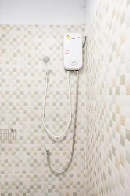 a shower in a tiled bathroom with a shower at Chummy House Khaosan 10-Min, Peace Haven in Bangkok