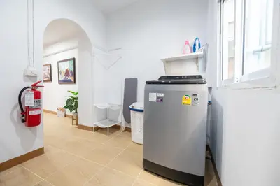 a kitchen with a refrigerator in a room at Chummy House Khaosan 10-Min, Peace Haven in Bangkok
