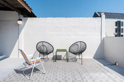 three chairs and a table on a roof at Chummy House Khaosan 10-Min, Peace Haven in Bangkok