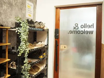 an open door to a room with shoes at Bed Space Hostel Khaosan in Bangkok