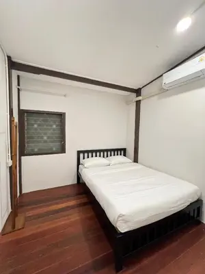 a bedroom with a bed in a room at House Ju in Bangkok