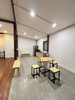 a room with two tables and benches in it at House Ju in Bangkok