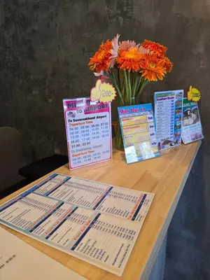 a table with a calendar and a vase of flowers at House Ju in Bangkok