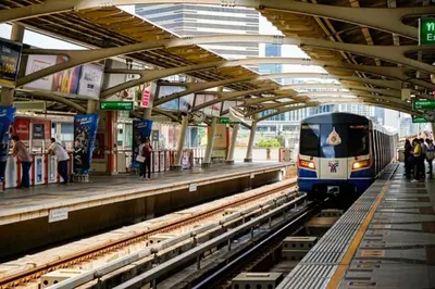 a train pulling into a train station with people waiting at The Palette Bangkok Hotel - Self check-in after 10 pm in Bangkok