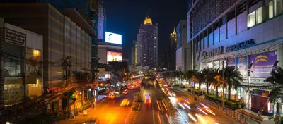 a busy city street at night with cars and buildings at The Palette Bangkok Hotel - Self check-in after 10 pm in Bangkok