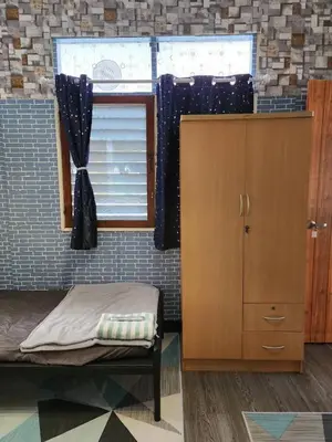 a small room with a bed and a window at 211 Spacious studio with breezy fan full amenities with free Wi-Fi in Bangkok